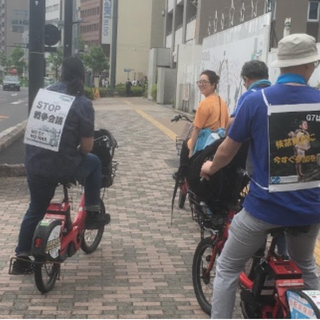 People riding bikes with signs