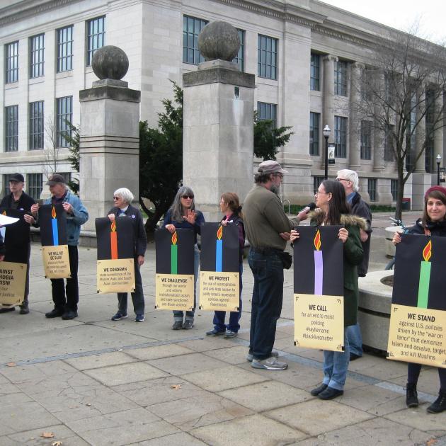 Members of Jewish Voice for Peace hold a symbolic menorah against racism and Islamophobia at the Ohio State University. 