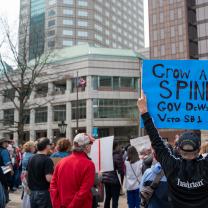 Sign says Grow A Spine Gov Dewine At Protest