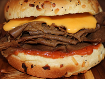 Big bun burger-looking sandwich close-up except it's like layers of beef (though not meat) with cheddar cheese (though not cheese)