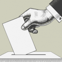 Hand putting ballot in box