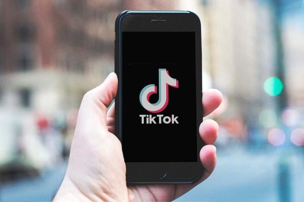 TikTok on iPhone in hand.  Photo is released under Creative Commons. Please use freely with attribution in the form of a link to nordskovmedia.dk as the image owner.
