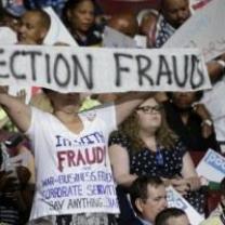 Bernie delegates holding up Election Fraud sign at DNC