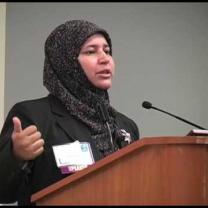 Muslim woman speaking at a mic
